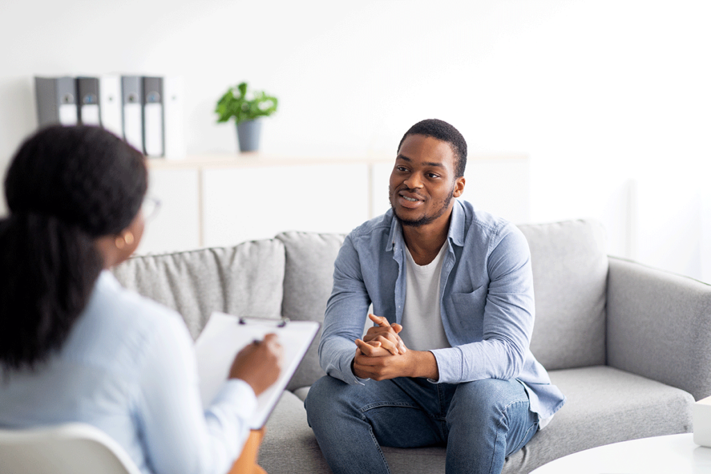 a man sits on a couch talking to therapist about most common dual diagnosis treatment services